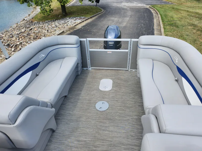 Slide: The Image of 2022 Bennington S 22 SSR pontoon boat interior with plush seating and outboard motor. - 13
