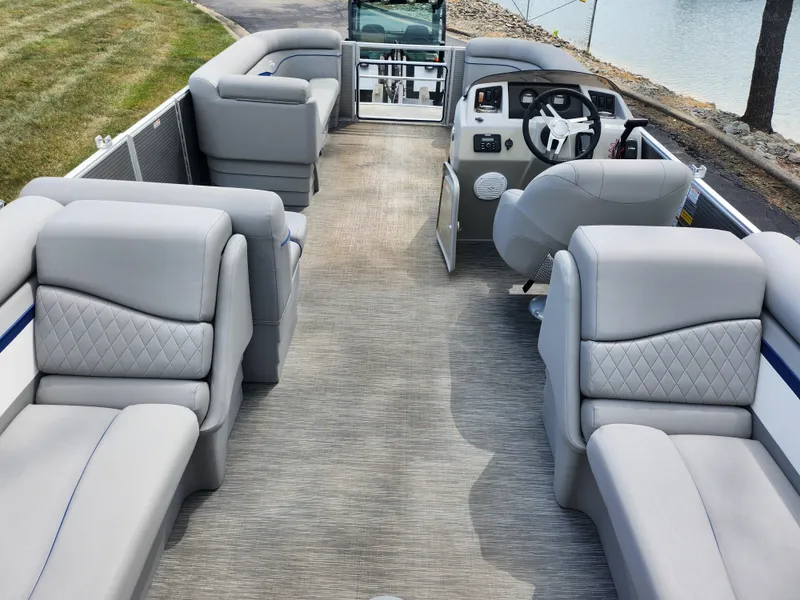 Slide: The Image of 2022 Bennington S 22 SSR pontoon boat interior with plush gray seating and steering console. - 15