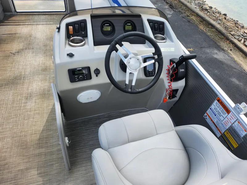 Slide: The Image of 2022 Bennington S 22 SSR boat dashboard with steering wheel and controls. - 16
