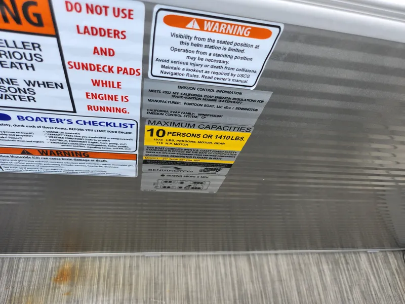Slide: The Image of Warning labels on 2022 Bennington S 22 SSR boat, maximum capacity 10 persons or 1410 lbs. - 17