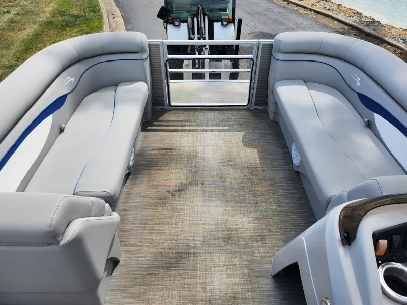 Slide: The Image of 2022 Bennington S 22 SSR pontoon boat interior with gray seating and open deck. - 18