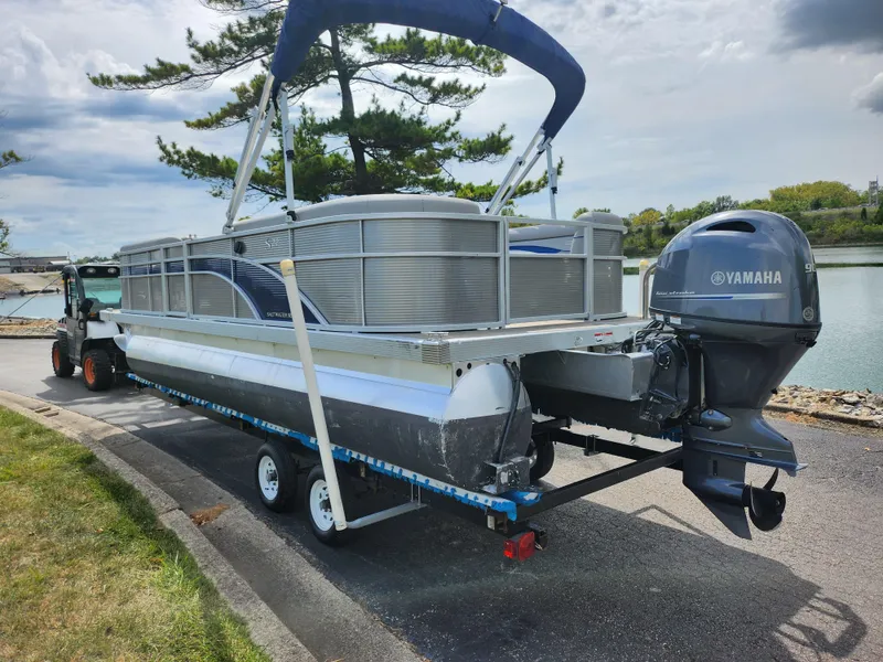 Slide: The Image of 2022 Bennington S 22 SSR pontoon boat on trailer with Yamaha outboard motor. - 2