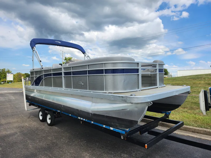 Slide: The Image of 2022 Bennington S 22 SSR pontoon boat on trailer under cloudy sky. - 6