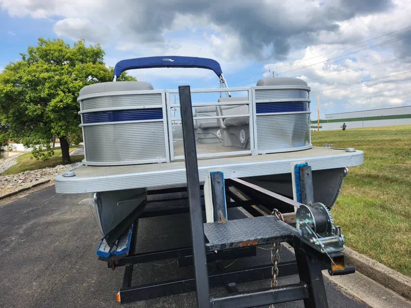 Slide: The Image of 2022 Bennington S 22 SSR pontoon boat on trailer under cloudy sky. - 7