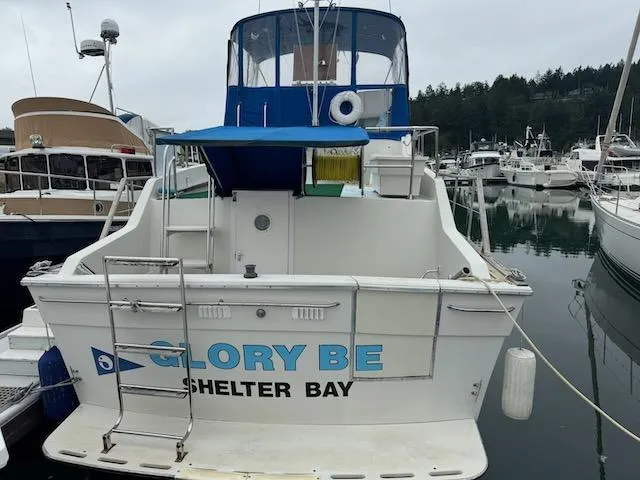 Slide: The Image of 1974 Tollycraft 40 Tri-Cabin boat named "Glory Be" docked at Shelter Bay marina. - 2
