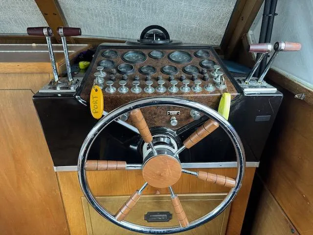 Slide: The Image of 1974 Tollycraft 40 Tri-Cabin helm with wooden steering wheel and control panel. - 22