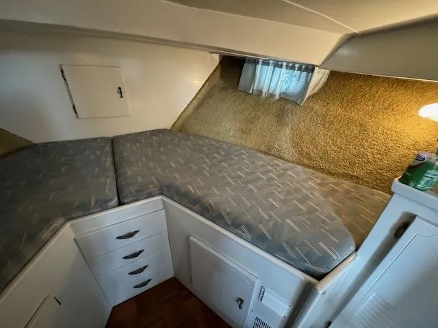 Slide: The Image of 1974 Tollycraft 40 Tri-Cabin interior with cozy bed and storage drawers. - 29