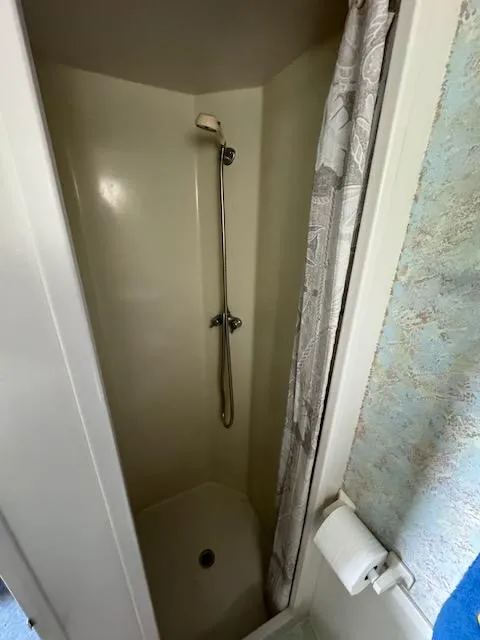 Slide: The Image of Shower area in 1974 Tollycraft 40 Tri-Cabin boat with curtain and handheld showerhead. - 34