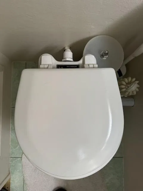 Slide: The Image of Toilet seat in a 1974 Tollycraft 40 Tri-Cabin boat bathroom. - 35