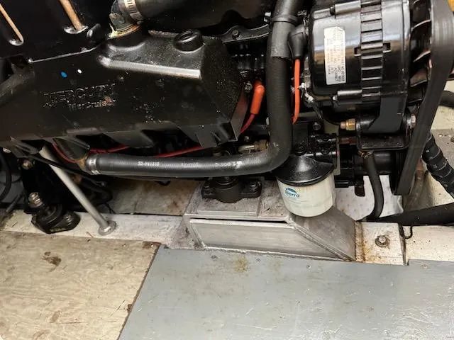 Slide: The Image of Engine compartment of a 1974 Tollycraft 40 Tri-Cabin boat, showing mechanical components. - 46