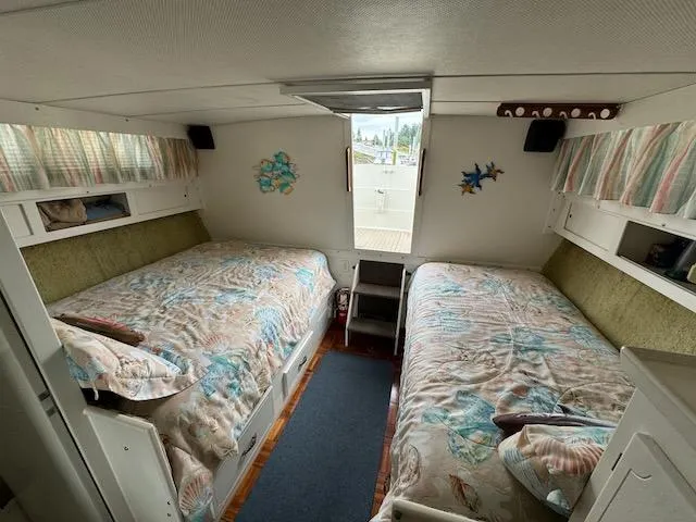 Slide: The Image of Cozy cabin interior of 1974 Tollycraft 40 Tri-Cabin with twin beds and nautical decor. - 5