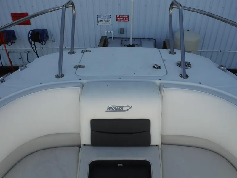 Slide: The Image of 2015 Boston Whaler 270 Vantage boat interior with seating and railing. - 16