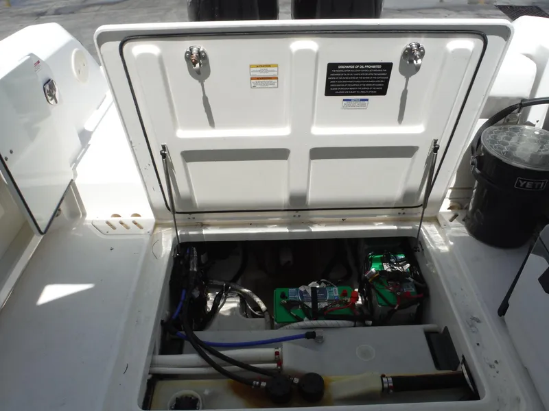 Slide: The Image of 2015 Boston Whaler 270 Vantage engine compartment with open hatch and visible components. - 30
