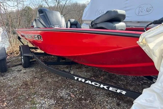 Slide: The Image of Red 2025 Tracker Pro Team 175 Crappie Edition boat on trailer, parked outdoors. - 88
