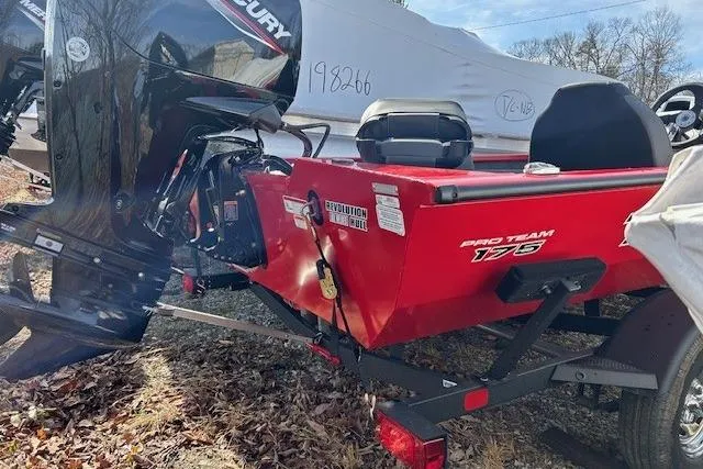 Slide: The Image of 2025 Tracker Pro Team 175 Crappie Edition boat, red exterior, parked outdoors. - 89
