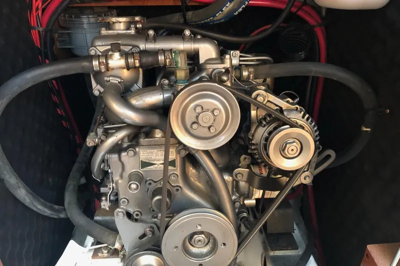 Slide: The Image of Engine of a 2004 Beneteau 331 sailboat, showcasing mechanical components and belts. - 14