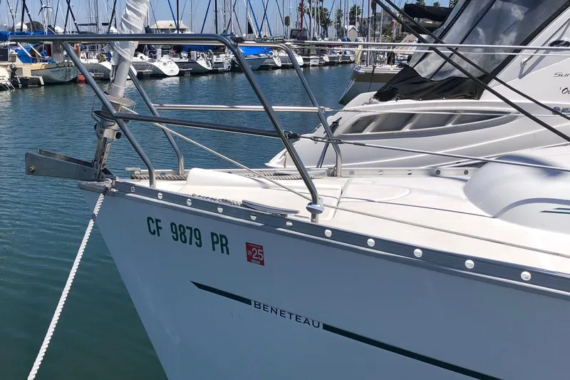 Slide: The Image of 2004 Beneteau 331 sailboat docked in marina, showcasing sleek design and registration number. - 16