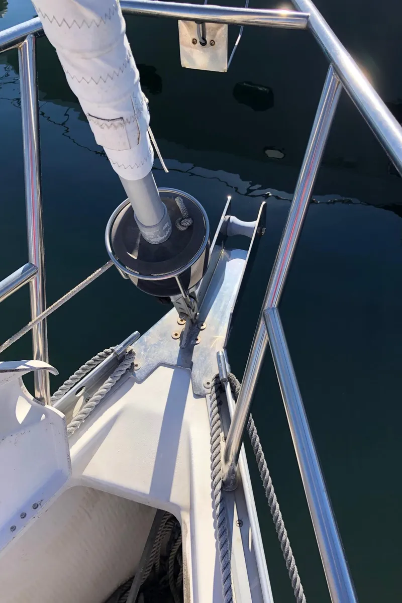 Slide: The Image of Bow of 2004 Beneteau 331 sailboat with stainless steel railing and furled sail. - 17