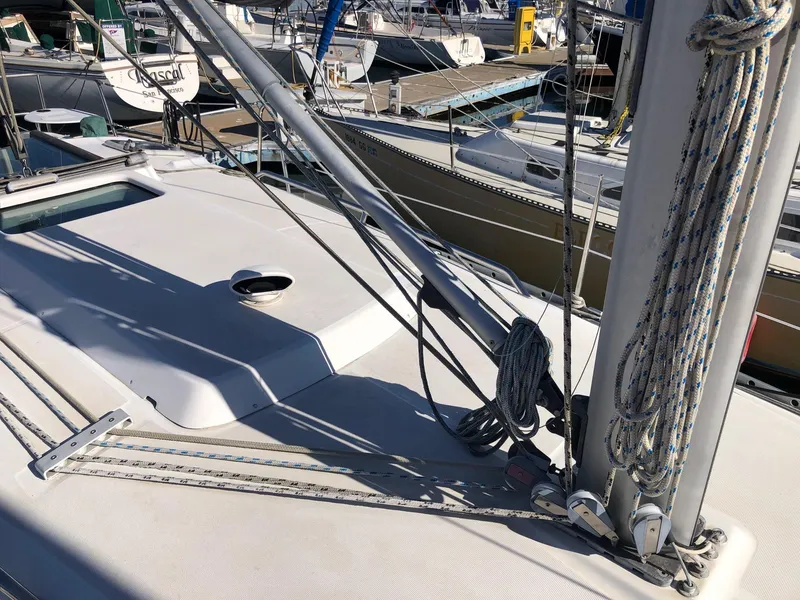 Slide: The Image of 2004 Beneteau 331 sailboat deck with rigging and ropes in marina. - 22