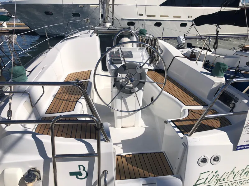 Slide: The Image of 2004 Beneteau 331 sailboat cockpit with teak seating and steering wheel. - 23