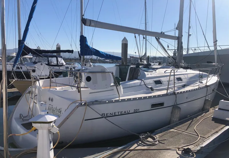 Slide: The Image of 2004 Beneteau 331 sailboat docked at marina under clear blue sky. - 28