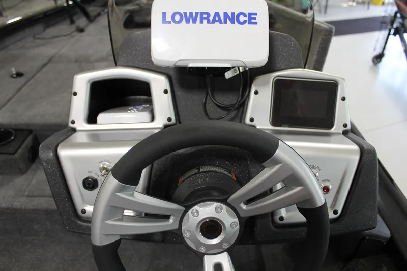 Slide: The Image of 2025 Tracker Pro Team 175 boat dashboard with Lowrance electronics and steering wheel. - 11