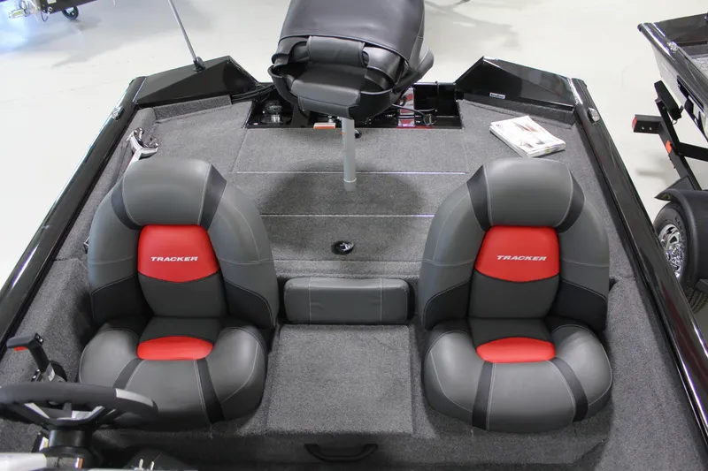 Slide: The Image of 2025 Tracker Pro Team 175 boat interior with gray and red seating. - 13