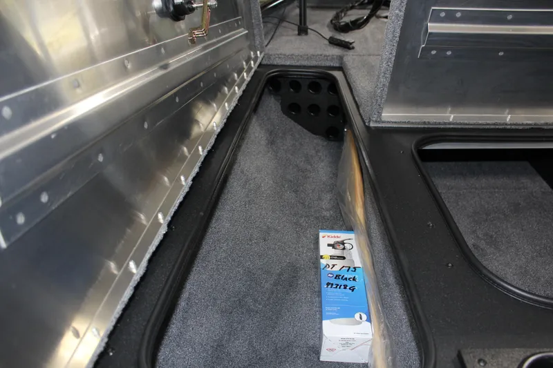 Slide: The Image of 2025 Tracker Pro Team 175 boat interior with storage compartment and accessory box. - 8