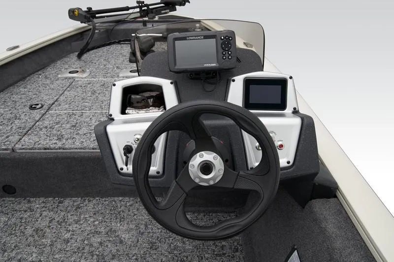 Slide: The Image of 2025 Tracker Pro Team 175 boat dashboard with steering wheel and electronic displays. - 3