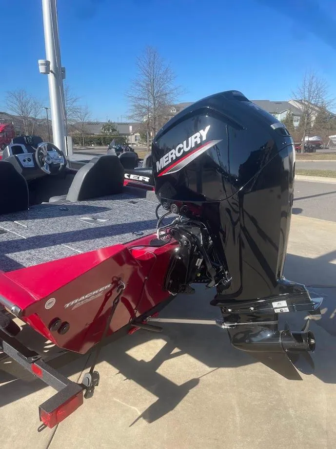 Slide: The Image of 2025 Tracker Pro Team 175 boat with Mercury outboard motor, parked outdoors. - 3