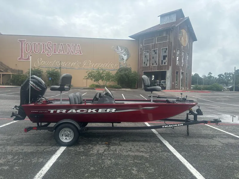 Slide: The Image of 2025 Tracker Pro 170 boat parked in front of Louisiana Sportsman's Paradise building. - 2