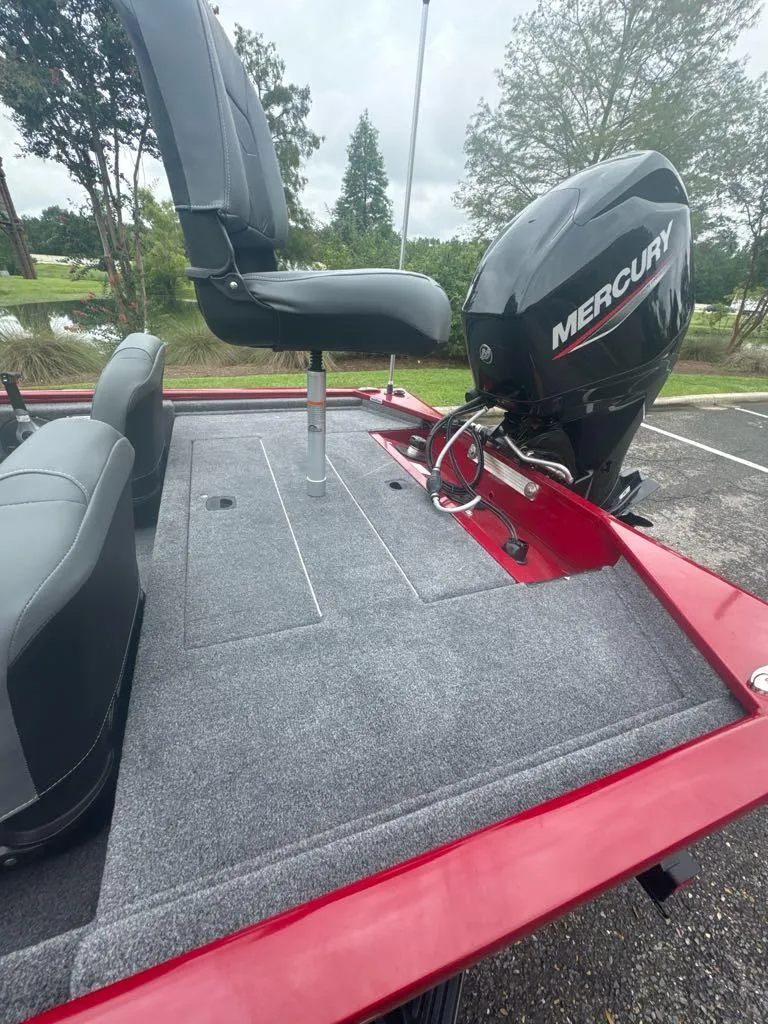 Slide: The Image of 2025 Tracker Pro 170 boat with Mercury engine, gray seating, and red trim. - 6