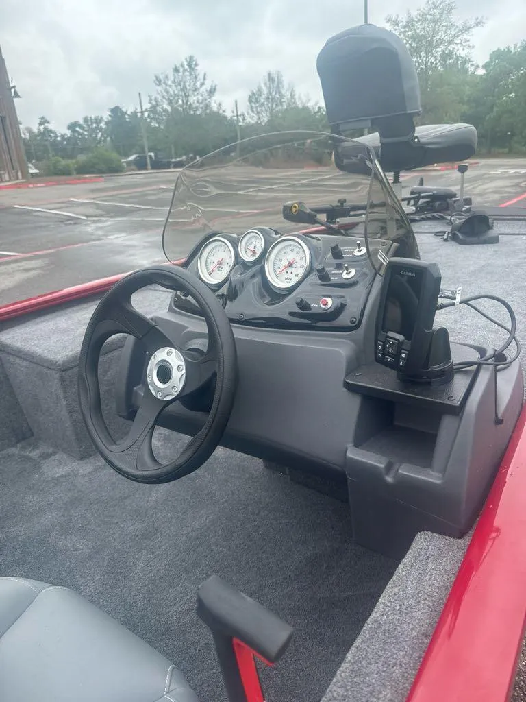 Slide: The Image of 2025 Tracker Pro 170 boat dashboard with steering wheel and gauges. - 7