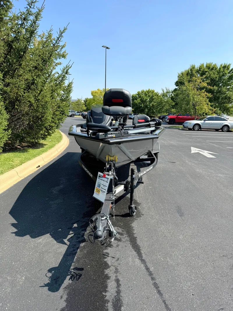 Slide: The Image of 2025 Tracker Pro Team 175 Crappie Edition boat parked in a sunny lot. - 2