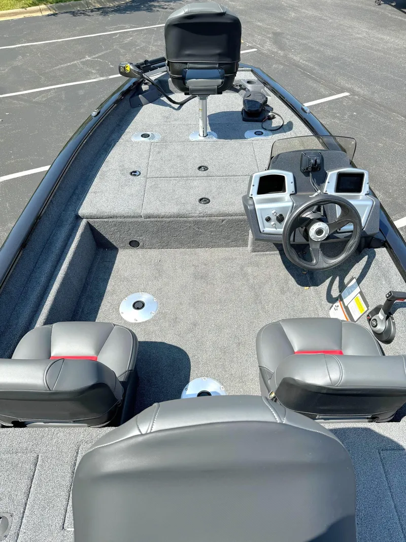 Slide: The Image of 2025 Tracker Pro Team 175 Crappie Edition boat interior with seating and steering console. - 3