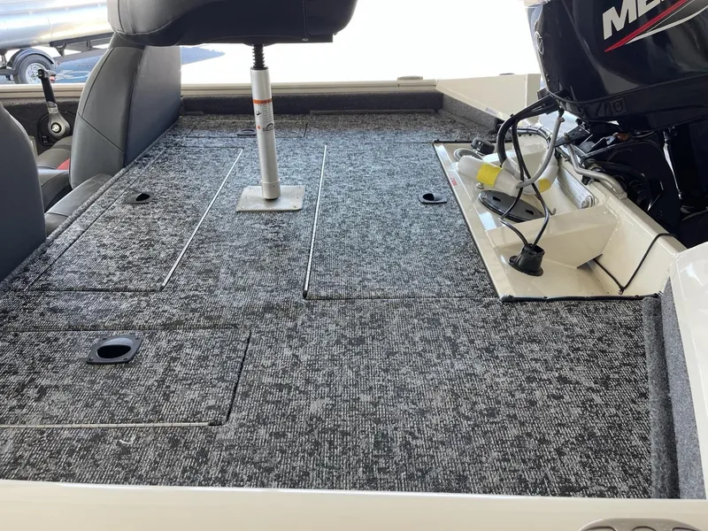Slide: The Image of 2025 Tracker Pro Team 175 boat interior with carpeted deck and seating. - 4