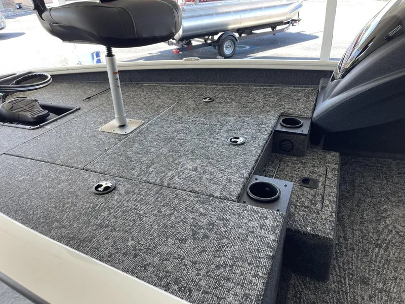 Slide: The Image of 2025 Tracker Pro Team 175 boat interior with seating and carpeted deck. - 6