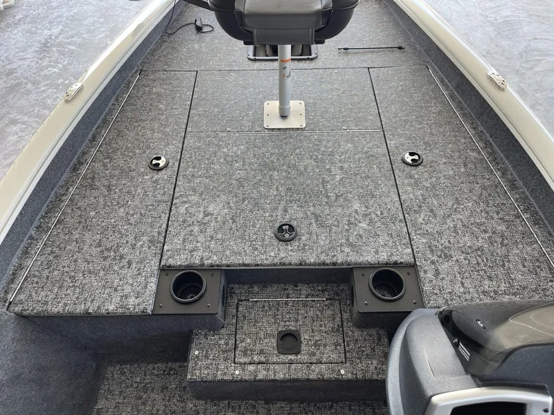 Slide: The Image of 2025 Tracker Pro Team 175 boat interior with gray carpet and seating. - 8