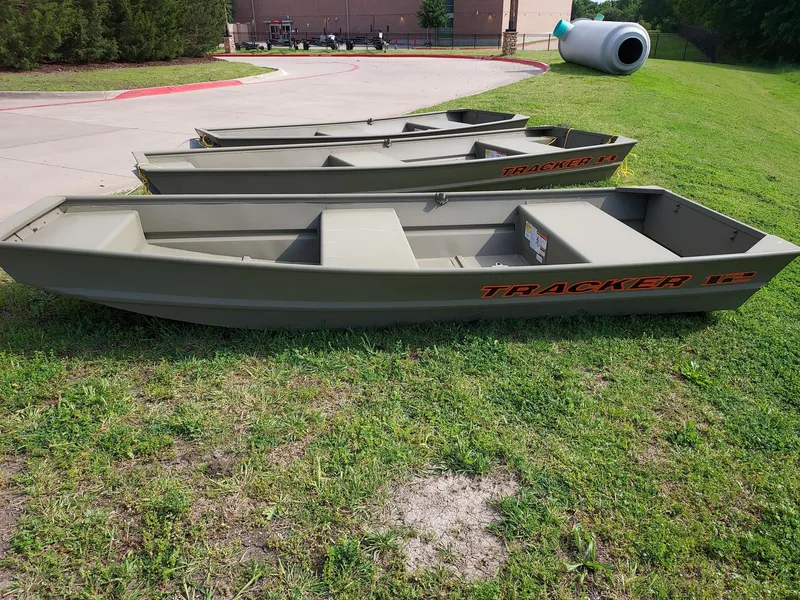 The Image of 2025 Tracker Grizzly 1236 Utility boat displayed in a store with various outdoor equipment. - 0