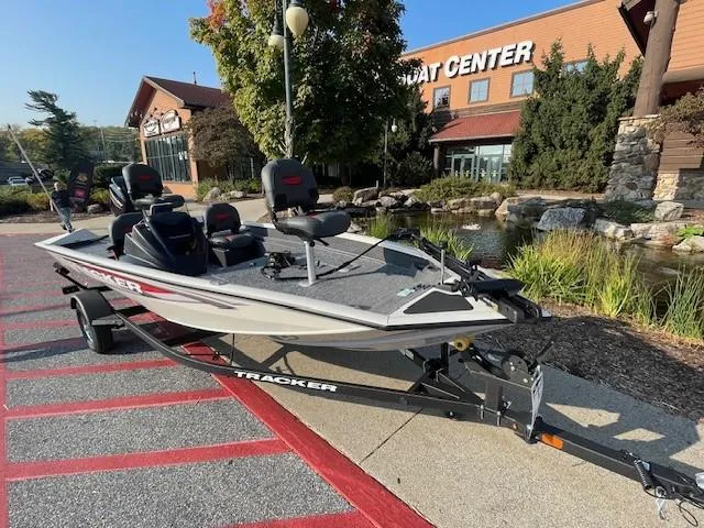 Slide: The Image of 2025 Tracker Pro Team 175 Crappie Edition boat on trailer outside boat center. - 2