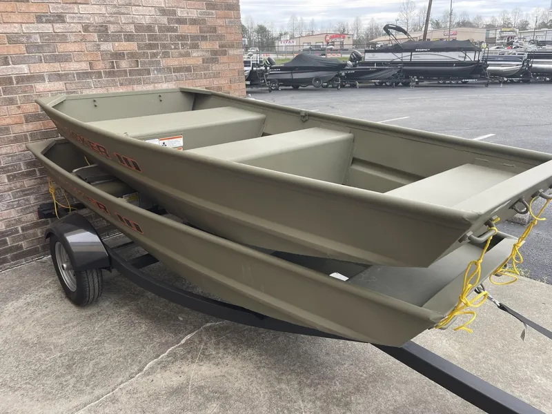 Slide: The Image of 2025 Tracker Grizzly 1036 Utility boat on trailer, parked outdoors. - 2
