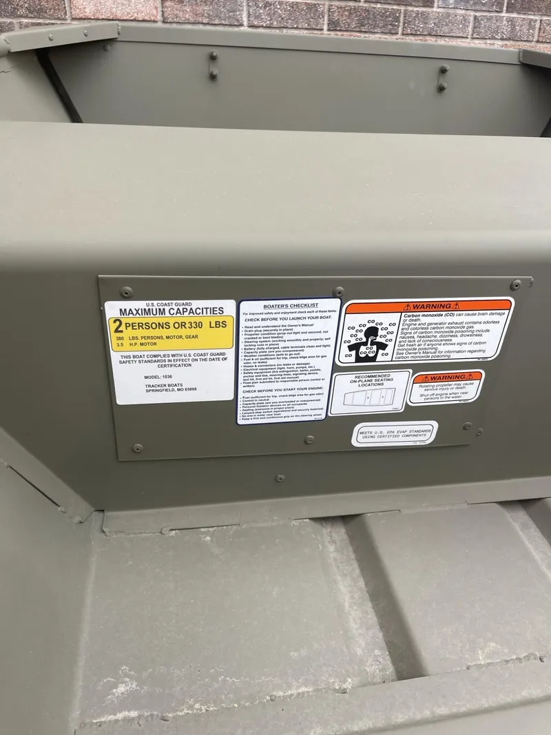 Slide: The Image of 2025 Tracker Grizzly 1036 Utility boat capacity and safety labels. - 3