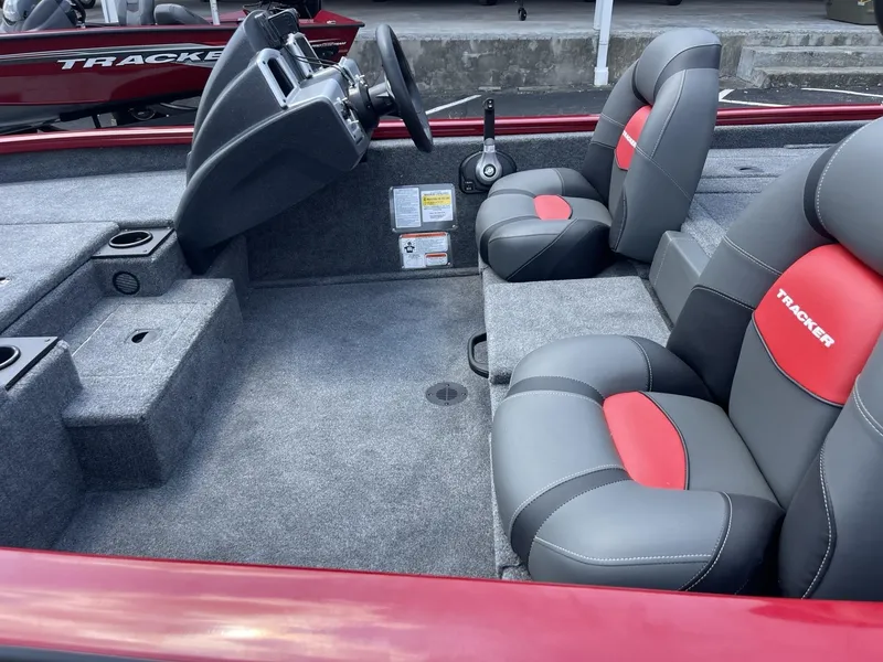 Slide: The Image of 2025 Tracker Pro Team 175 boat interior with gray and red seating. - 5