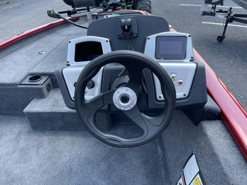 Slide: The Image of 2025 Tracker Pro Team 175 boat dashboard with steering wheel and control panels. - 6