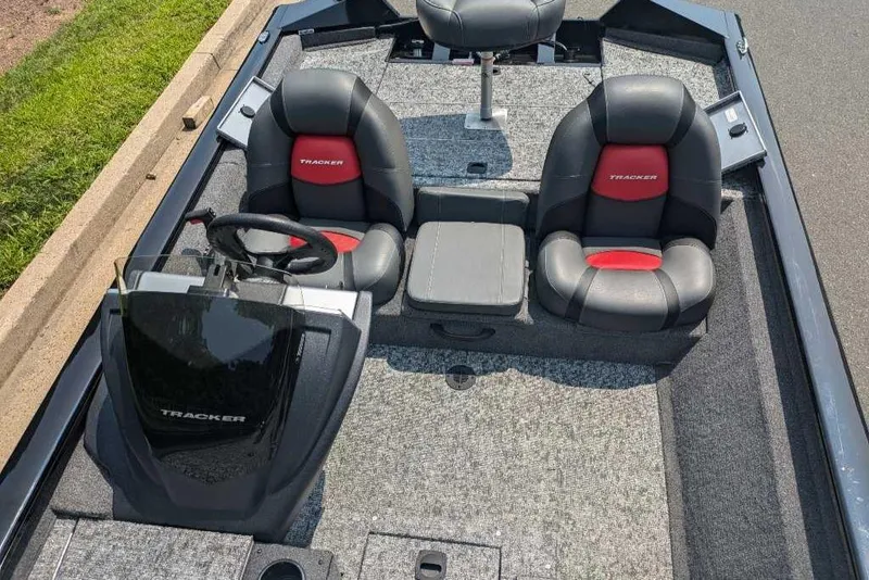 Slide: The Image of 2025 Tracker Pro Team 175 boat interior with dual seats and steering console. - 2