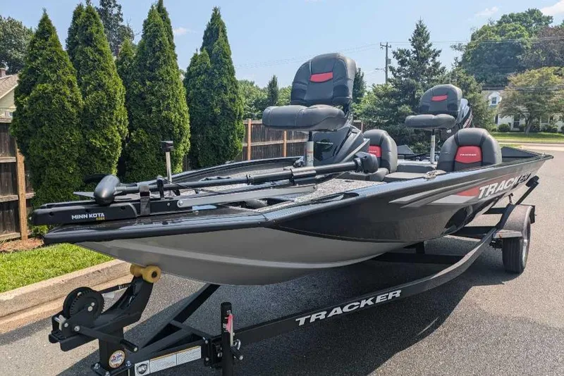 Slide: The Image of 2025 Tracker Pro Team 175 fishing boat on trailer, parked outdoors. - 3