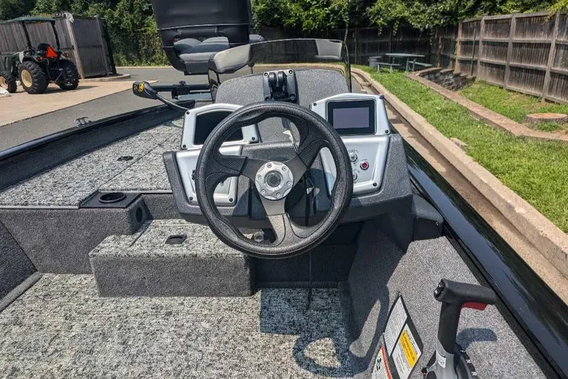 Slide: The Image of 2025 Tracker Pro Team 175 boat interior with steering wheel and control panel. - 4