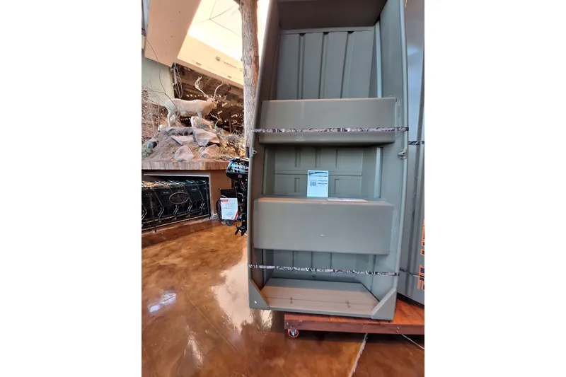 The Image of 2025 Tracker Grizzly 1036 Utility boat displayed indoors with wildlife decor. - 0