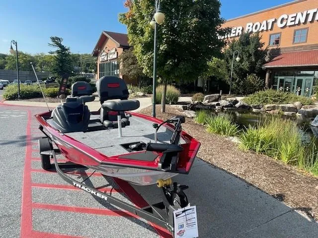 Slide: The Image of 2025 Tracker Pro Team 175 boat displayed outside a boat center. - 2