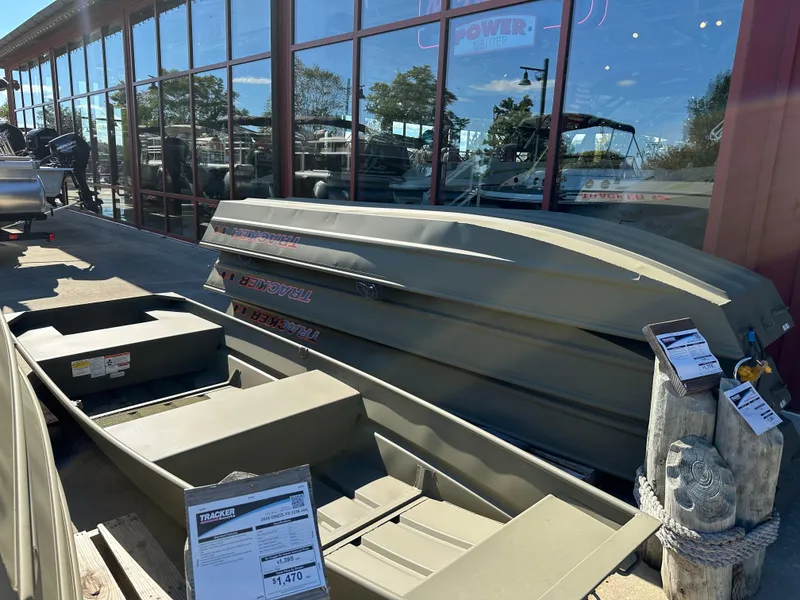 Slide: The Image of 2025 Tracker Grizzly 1036 Utility boat displayed outside a showroom. - 26